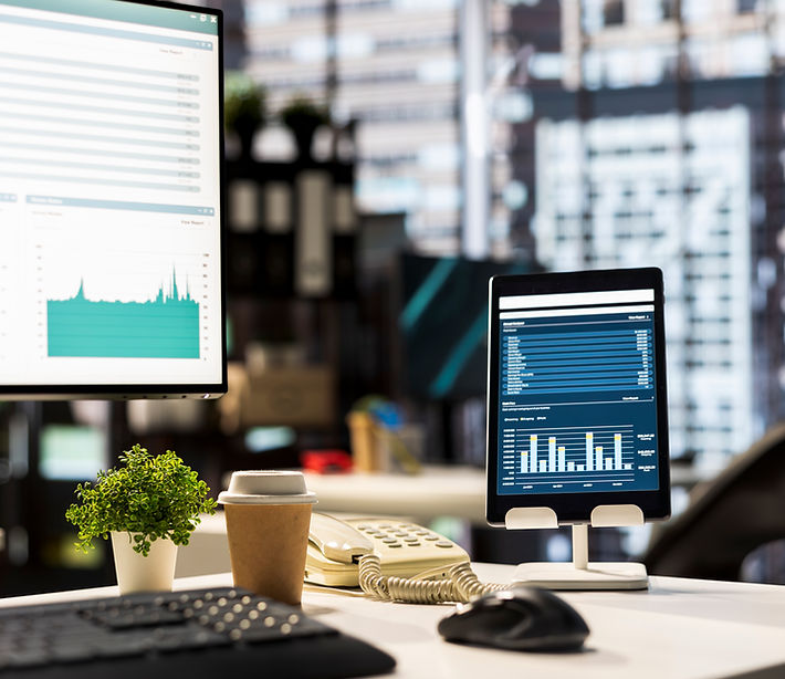 A small business workspace with bookkeeping and payroll reporting on screen