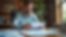 Eye-level view of a small business owner reviewing financial documents in a cozy Greenville office